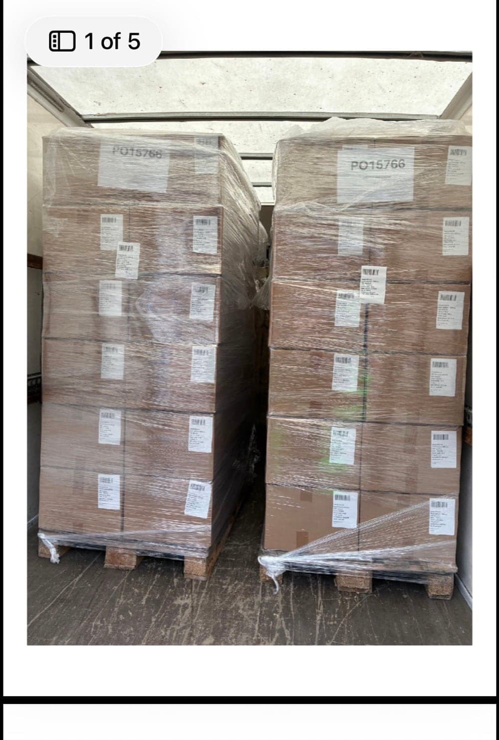 Two wrapped pallets loaded and secured inside a Raymond Logistics trailer